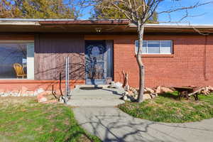 Property entrance featuring brick siding