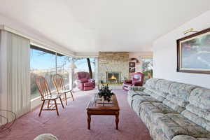 Living room featuring a fireplace and carpet floors