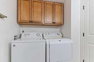 Laundry room featuring cabinet space and washing machine and dryer