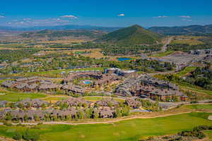Aerial overview of property's location featuring mountains and nearby suburban area