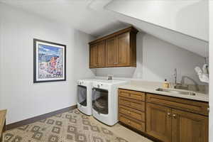 Washroom with cabinet space, separate washer and dryer, and lofted ceiling