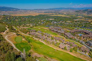 View of property location with nearby suburban area, mountains, and a local golf course