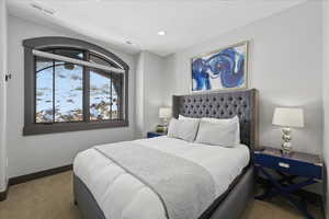 Bedroom featuring carpet floors and baseboards