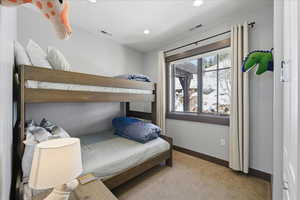 Bedroom with light colored carpet and recessed lighting