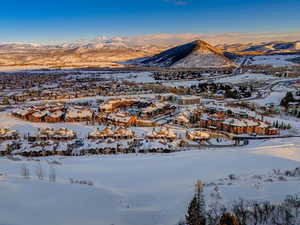 Snowy aerial view featuring a mountain view and a residential view