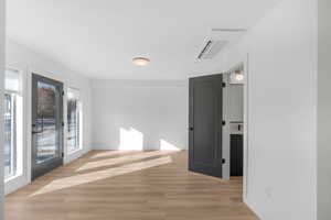 Spare room with light wood finished floors and cooling unit