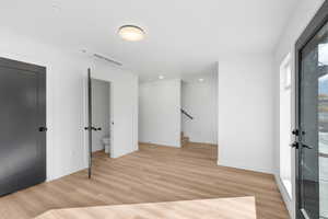 Foyer with light wood finished floors and stairway