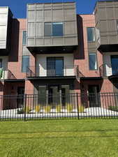 View of front facade with brick siding and stucco siding