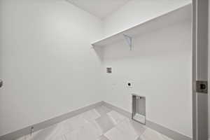 Laundry room with hookup for a washing machine and electric dryer hookup