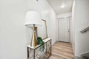 Entryway with wood finished floors and baseboards