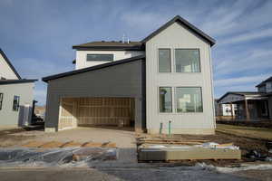 View of the back of the home and garage