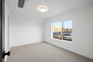 Empty room with carpet floors and cooling unit