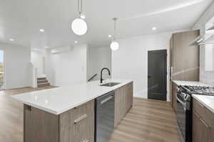 Kitchen with recessed lighting, pendant lighting, modern cabinets, and light wood-style flooring