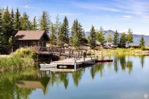 Dock area featuring a water and mountain view and a sunroom