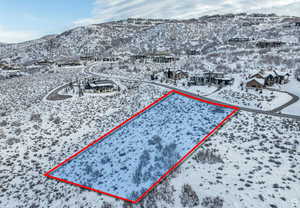 Snowy aerial view featuring a mountain view