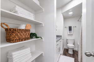 Full bath with vanity, dark wood-type flooring, and shower / bath combination with curtain