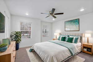 Carpeted bedroom with ceiling fan and recessed lighting