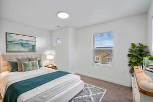 Carpeted bedroom featuring baseboards