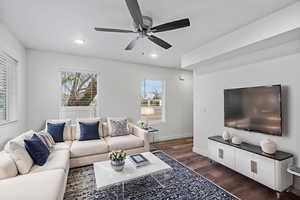 Living area with dark wood-type flooring, a ceiling fan, and recessed lighting