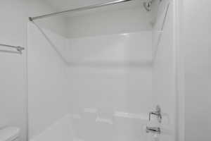 Bathroom featuring  shower combination and toilet