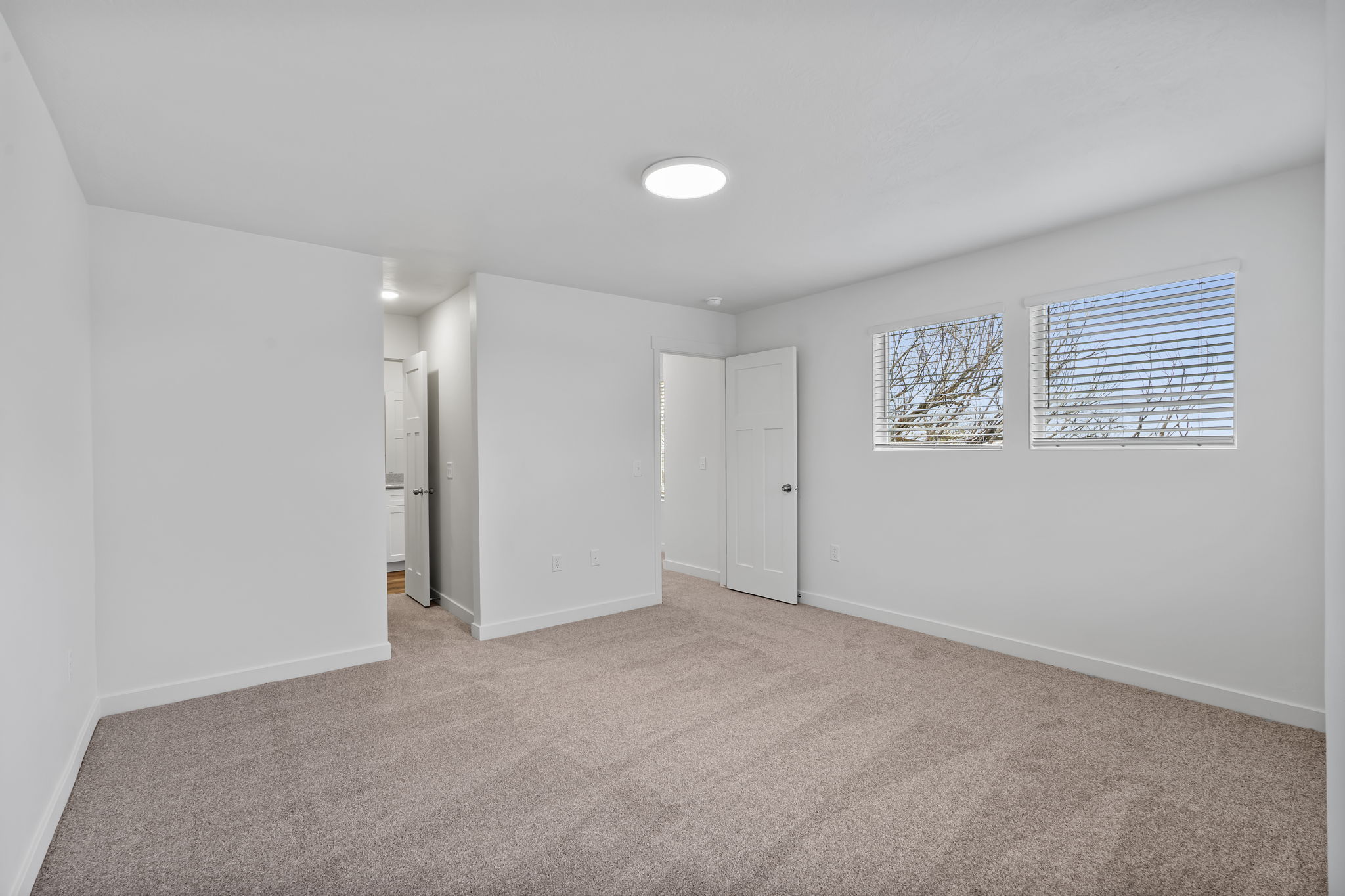 Unfurnished bedroom with carpet flooring and baseboards