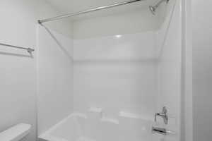 Bathroom with shower / washtub combination and toilet