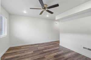 Spare room featuring ceiling fan, dark wood-style flooring, and recessed lighting