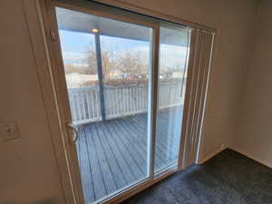 Entryway with carpet floors and a water view