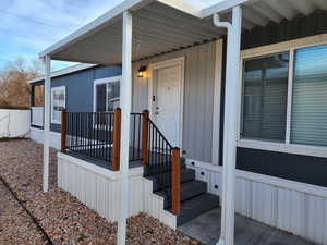 View of exterior entry featuring covered porch