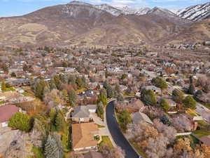 Aerial view of property's location with nearby suburban area and a mountain backdrop