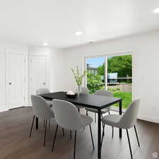 Dining space featuring dark wood-style floors and recessed lighting