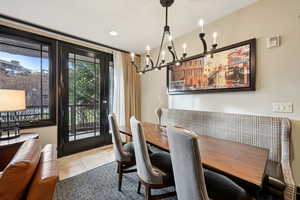 Dining room with a chandelier and light tile patterned floors