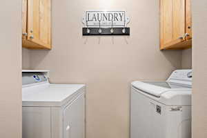 Laundry room with cabinet space and washer and dryer
