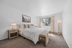 Bedroom featuring carpet flooring and baseboards