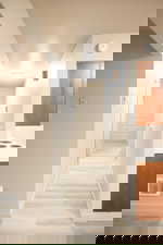 Hallway with light wood-type flooring and baseboards