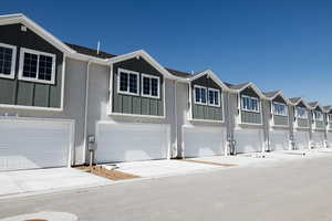 View of front facade featuring board and batten siding and a residential view