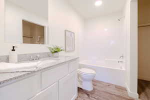 Full bathroom with vanity, shower / tub combination, and light wood-style floors