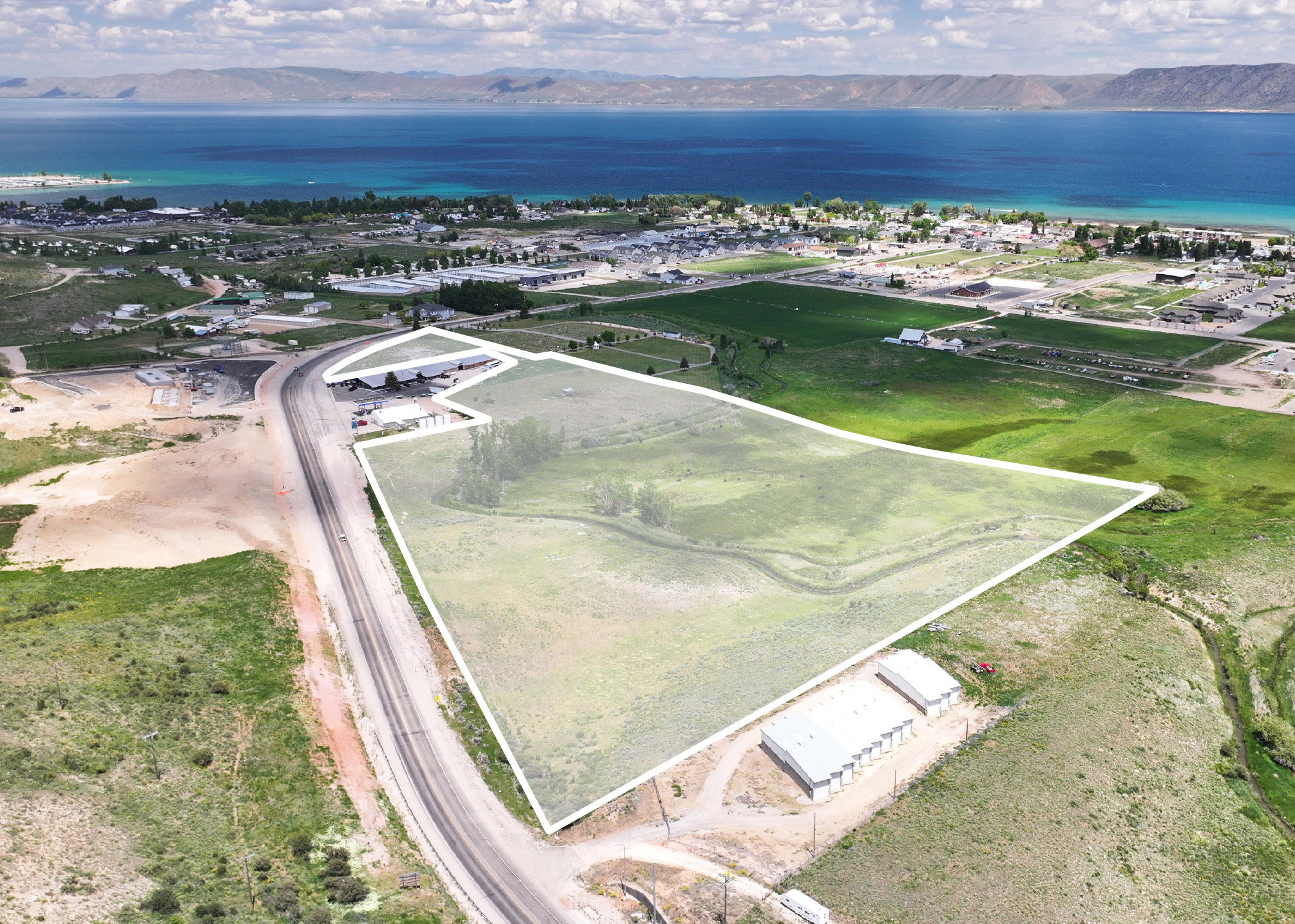 Aerial view of property's location with a water and mountain view and property parcel outlined