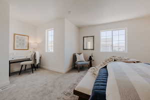 Bedroom featuring carpet floors and baseboards