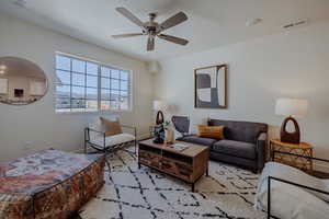 Living room with a ceiling fan and baseboards