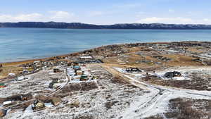 Aerial view of property's location featuring a mountainous background and nearby suburban area