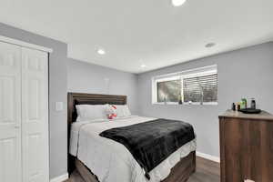 Bedroom with wood finished floors, a closet, recessed lighting, and a textured ceiling