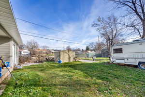 Fenced backyard with a storage unit
