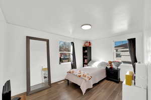 Bedroom featuring dark wood-type flooring