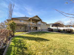 Back of house with a patio area, stairs, a balcony, and stucco siding