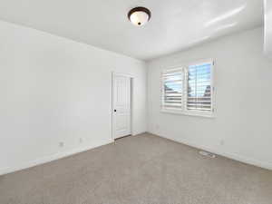 Spare room with carpet flooring and baseboards