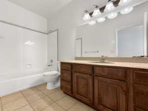 Bathroom with vanity,  shower combination, and light tile patterned floors