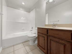 Full bath with vanity, light tile patterned floors, bathing tub / shower combination, and recessed lighting