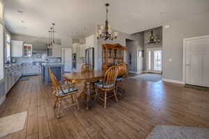 Dining room featuring wood tiled floors, a chandelier, and recessed lighting
