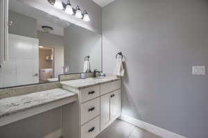 Bathroom with vanity and light tile patterned floors